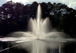 A very large commercial water fountain in a lake.